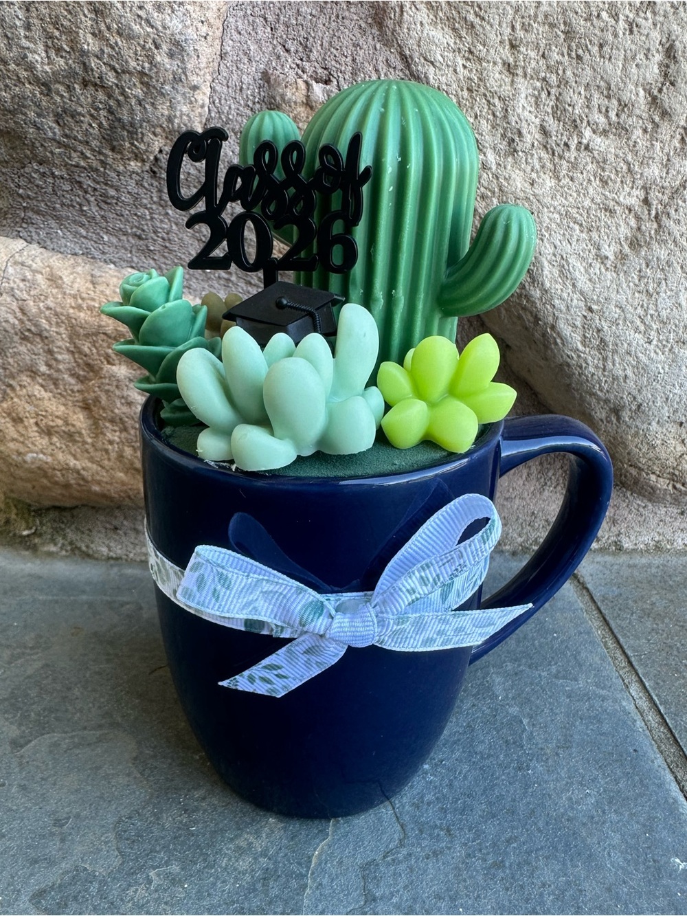 Graduation wax succulent arrangement in a coffee mug